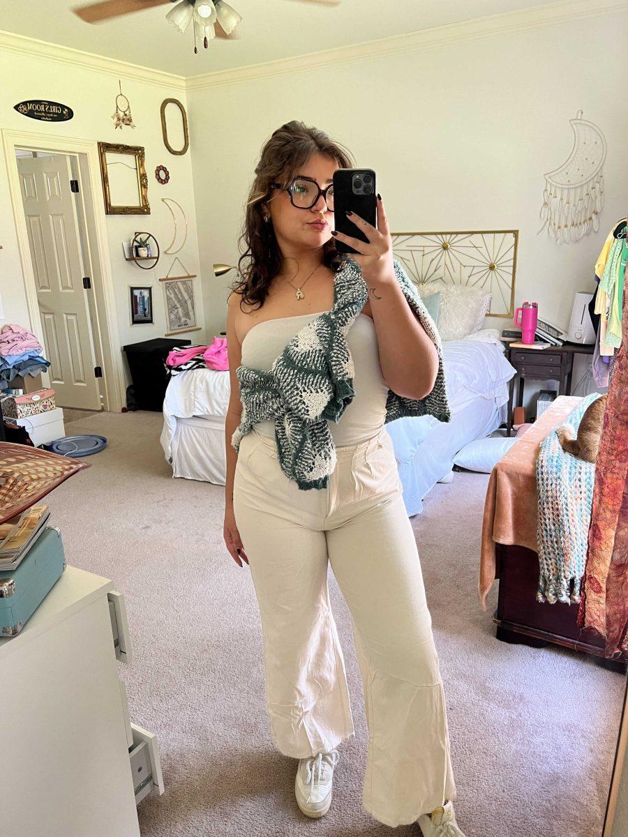 <p>Senior, Riley Lawson, captures a picture of an everyday outfit in her mirror</p>