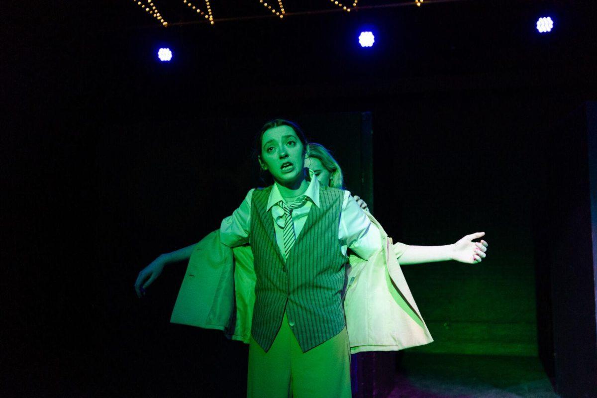 Older Nick Carraway (Sophie Rollins) gives younger Nick Carraway (Emily Pounds) her jacket in a production of Yearning Sunday, March 3, 2024, in Coates Hall on LSU's campus.