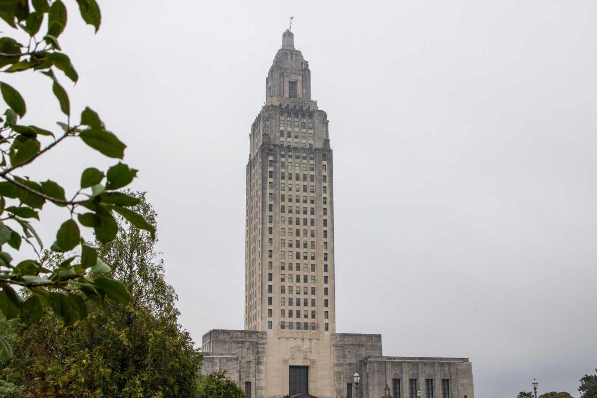 Tree branches frane the Louisiana State Capitol while it sits on a cloudy day on Friday, March 1, 2024, in Baton Rouge, La.