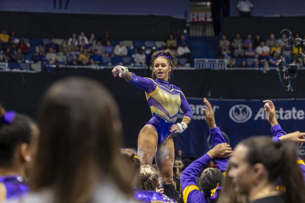 LSU gymnastics junior all-around KJ Johnson points to her teammates during her floor exercise routine Saturday, March 23, 2024, during LSU's 198.075 victory in the 2024 SEC Gymnastics Championship in the Smoothie King Center in New Orleans, La.