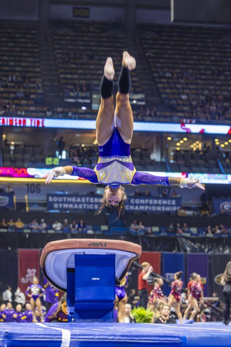 LSU gymnastics junior all-around KJ Johnson flips through the air Saturday, March 23, 2024, during LSU's 198.075 victory in the 2024 SEC Gymnastics Championship in the Smoothie King Center in New Orleans, La.