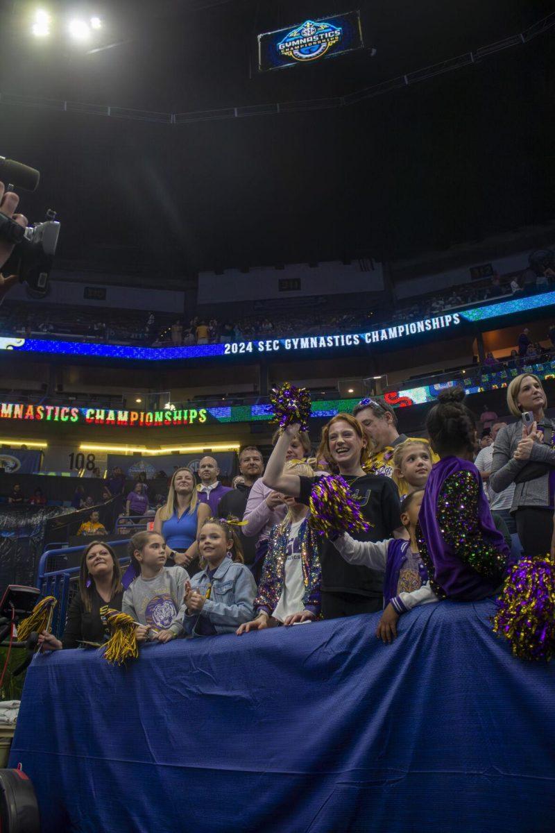 LSU gymnastics fans celebrate with the gymnastics team Saturday, March 23, 2024, following LSU's 198.075 victory in the 2024 SEC Gymnastics Championship in the Smoothie King Center, New Orleans, La.