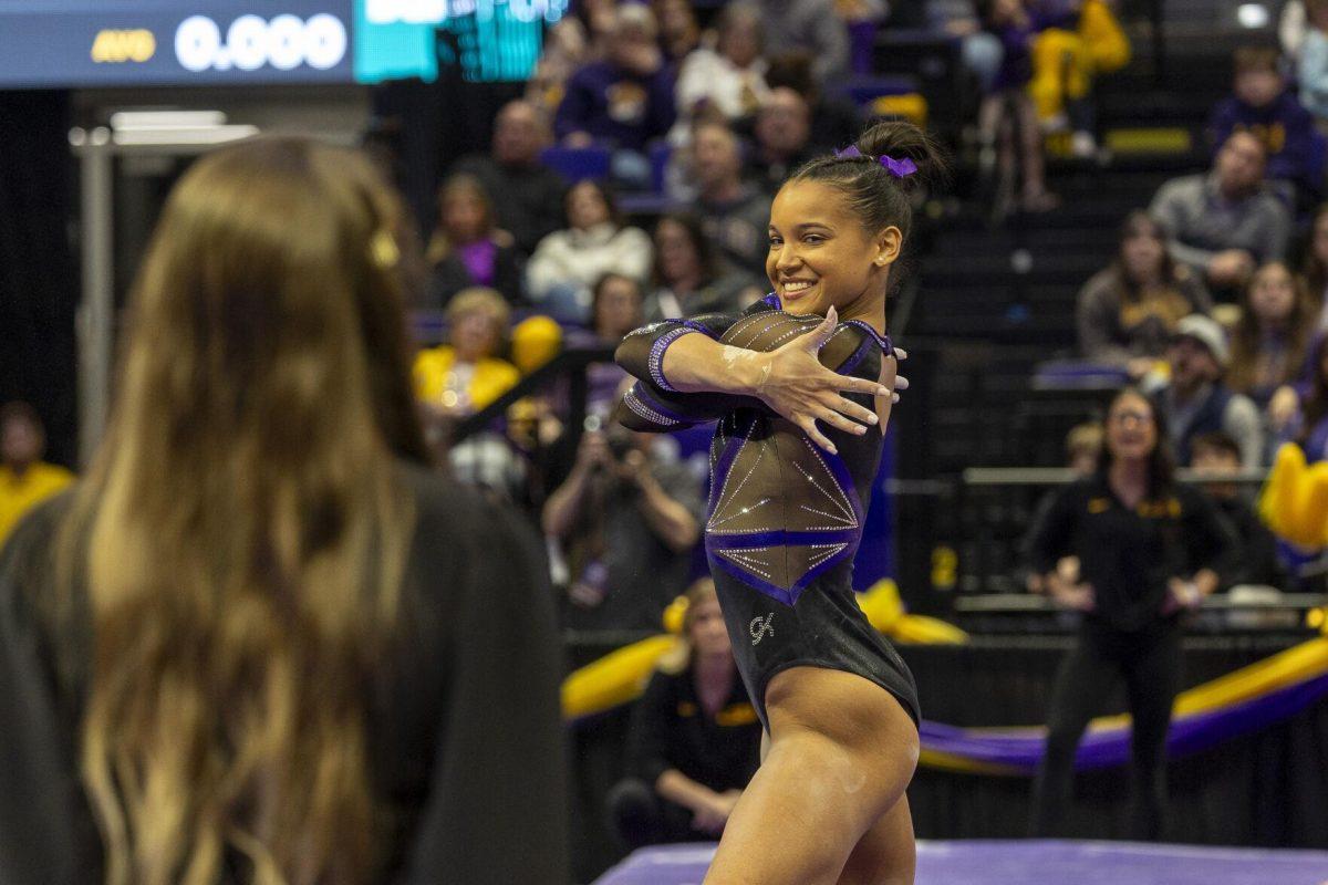 LSU gymnastics senior all-around Haleigh Bryant smiles at assistant Courtney Griffeth Friday, March 1, 2024, during LSU's 198.325-197.325 win over Alabama in the Pete Maravich Assembly Center.