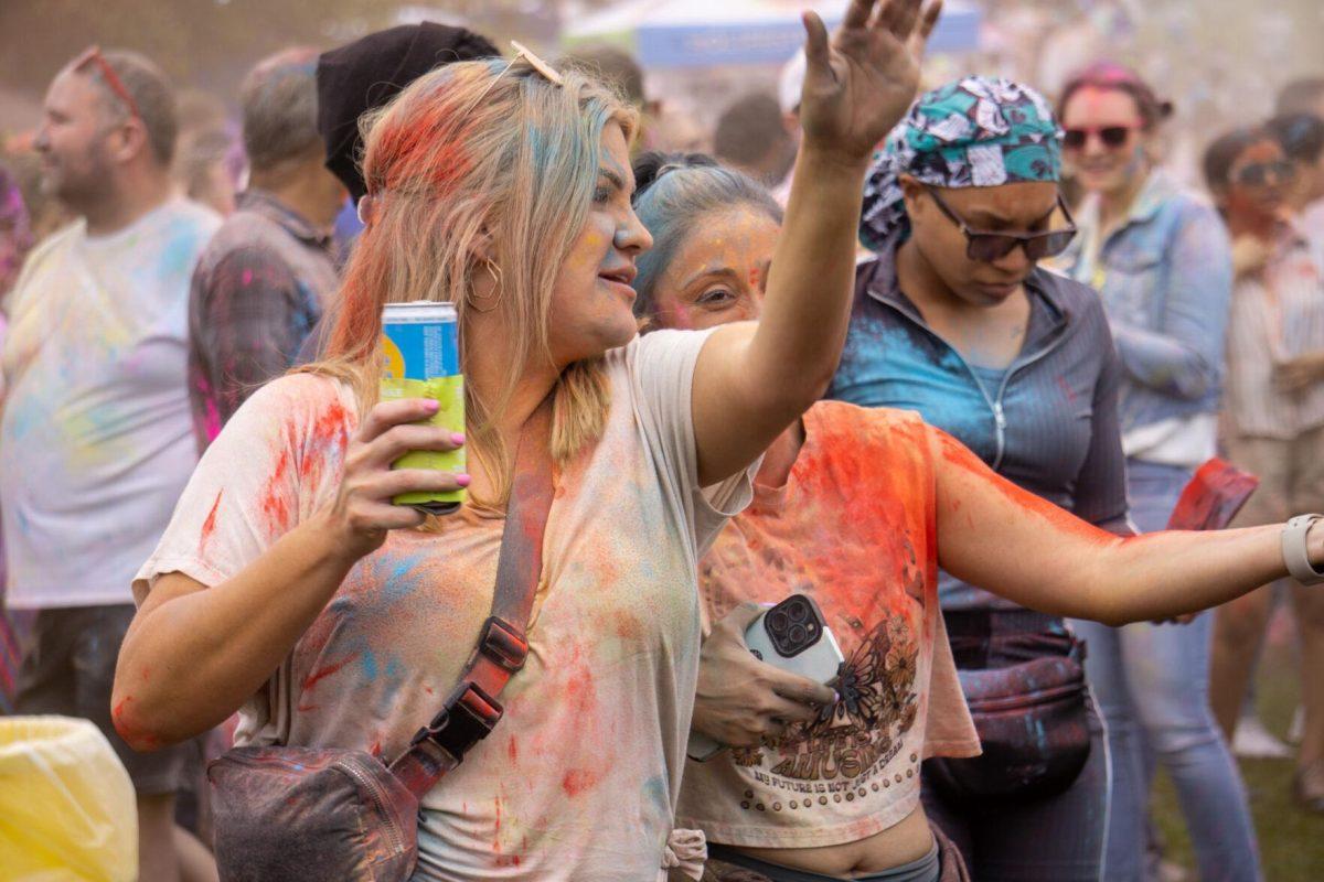 Holi festival participants throw powder Saturday, March 9, 2024, at the Holi Festival at Repentance Park in Baton Rouge La.