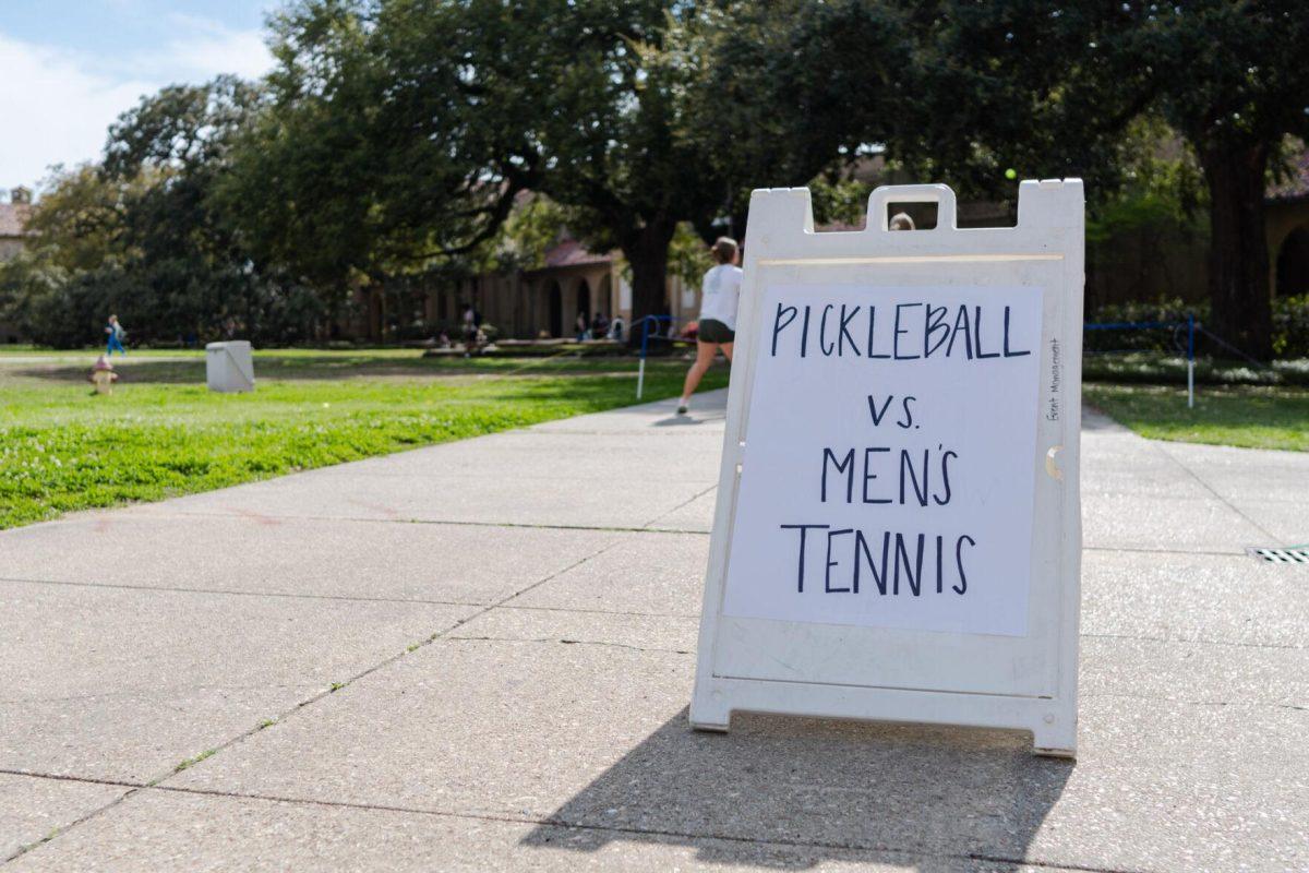 A sign reads "Pickleball vs. Men's Tennis" Thursday, March 7, 2024, in the Quad on LSU's campus in Baton Rouge, La.