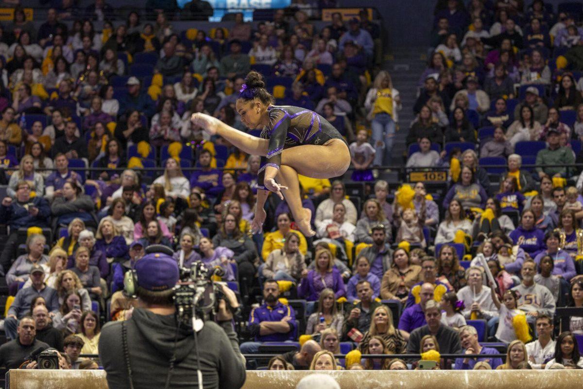 LSU gymnastics freshman all-around Konnor McClain glides through the air Friday, March 1, 2024, during LSU's 198.325-197.325 win over Alabama in the Pete Maravich Assembly Center.