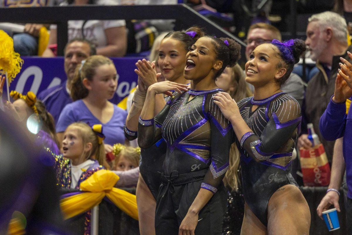 The LSU gymnastics team watches graduate student Sierra Ballard perform her routine Friday, March 1, 2024, during LSU's 198.325-197.325 win over Alabama in the Pete Maravich Assembly Center.