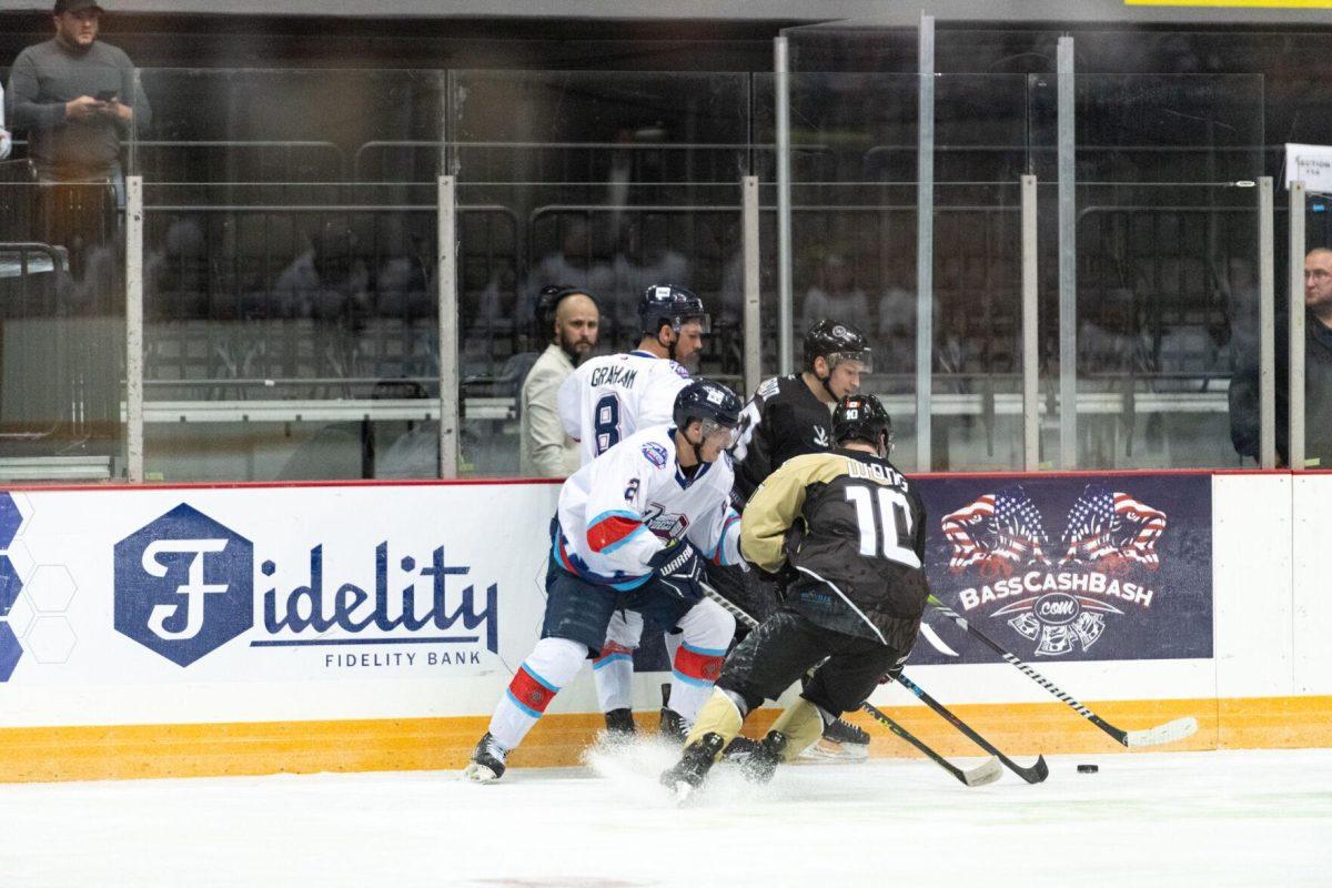 Baton Rouge Zydeco hockey pro forward Curtis Hansen (2) and veteran forward MJ Graham (8) attempt to steal the puck Thursday, Feb. 29, 2024, during Zydeco's 5-3 win against the Carolina Thunderbirds at the Raising Canes River Center in Baton Rouge, La.