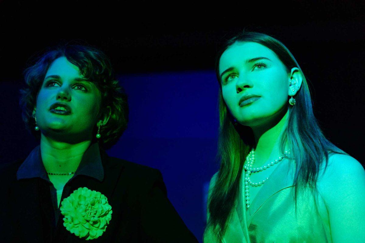 Jane Gatsby (Ava Russell) and Daisy Buchanan (Elyse Nave) look into the green light in a production of Yearning Sunday, March 3, 2024, in Coates Hall on LSU's campus.