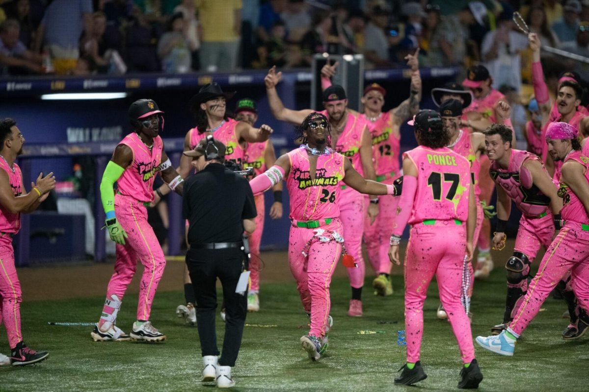 Party Animals catcher Taj Porter (26) makes a Louisiana-themed entrance Thursday, March 14, 2024, during the Savannah Bananas 5-4 loss to the Party Animals during their world tour stop at Alex Box Stadium in Baton Rouge, La.