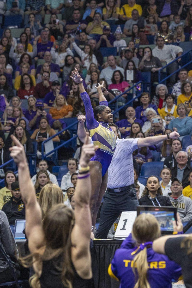 LSU gymnastics graduate student Kiya Johnson makes her stick Saturday, March 23, 2024, during LSU's 198.075 victory in the 2024 SEC Gymnastics Championship in the Smoothie King Center in New Orleans, La.