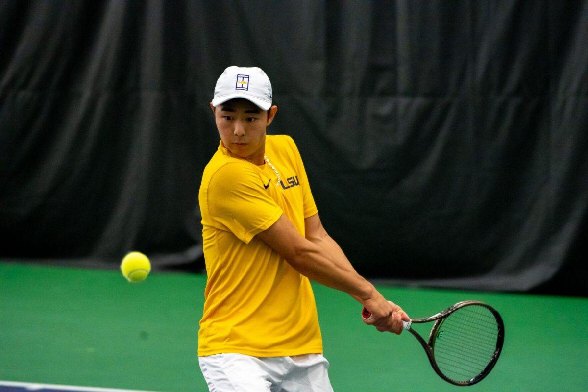 LSU men's tennis senior Chen Dong hits a backhand during his unfinished 7-6, 5-5 doubles match against Ole Miss Friday, March 8, 2024, at the LSU tennis complex on Gourrier Avenue in Baton Rouge, La.