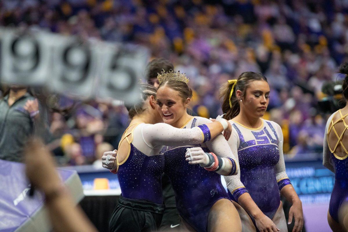 LSU gymnastics graduate student all-around Savannah Schoenherr hugs a teammate Friday, March 15, 2024, during LSU's 198.250-196.075 win against North Carolina at the Pete Maravich Assembly Center in Baton Rouge, La.