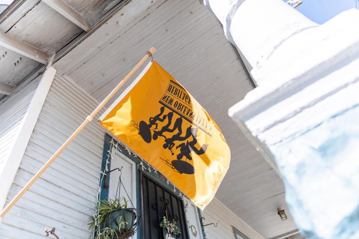 A Jazz Fest flag flies upside down Friday, March 29, 2024, on Fortin Street in New Orleans, La.