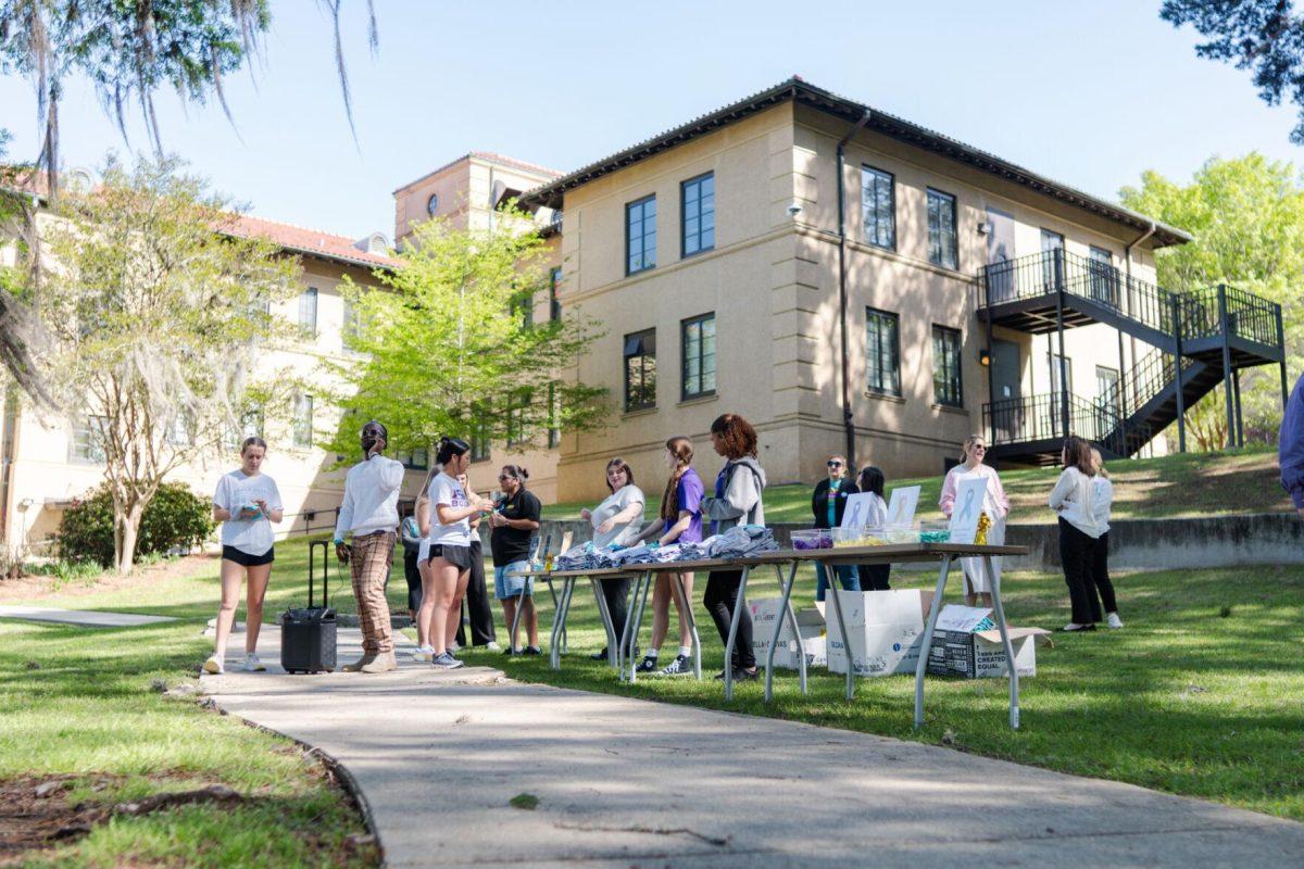 Attendees check in at the tables Tuesday, March 26, 2024, at the Believe March on LSU's campus.