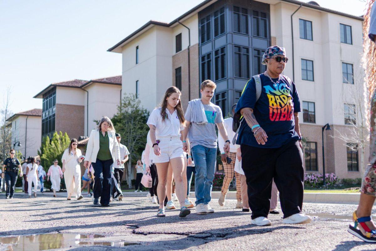 Attendees walk the route in silence Tuesday, March 26, 2024, at the Believe March on LSU's campus.