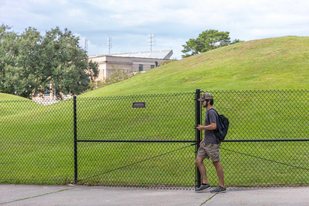 A student walks by the LSU Indian Mounds Thursday, Aug. 25, 2022, on LSU's campus.