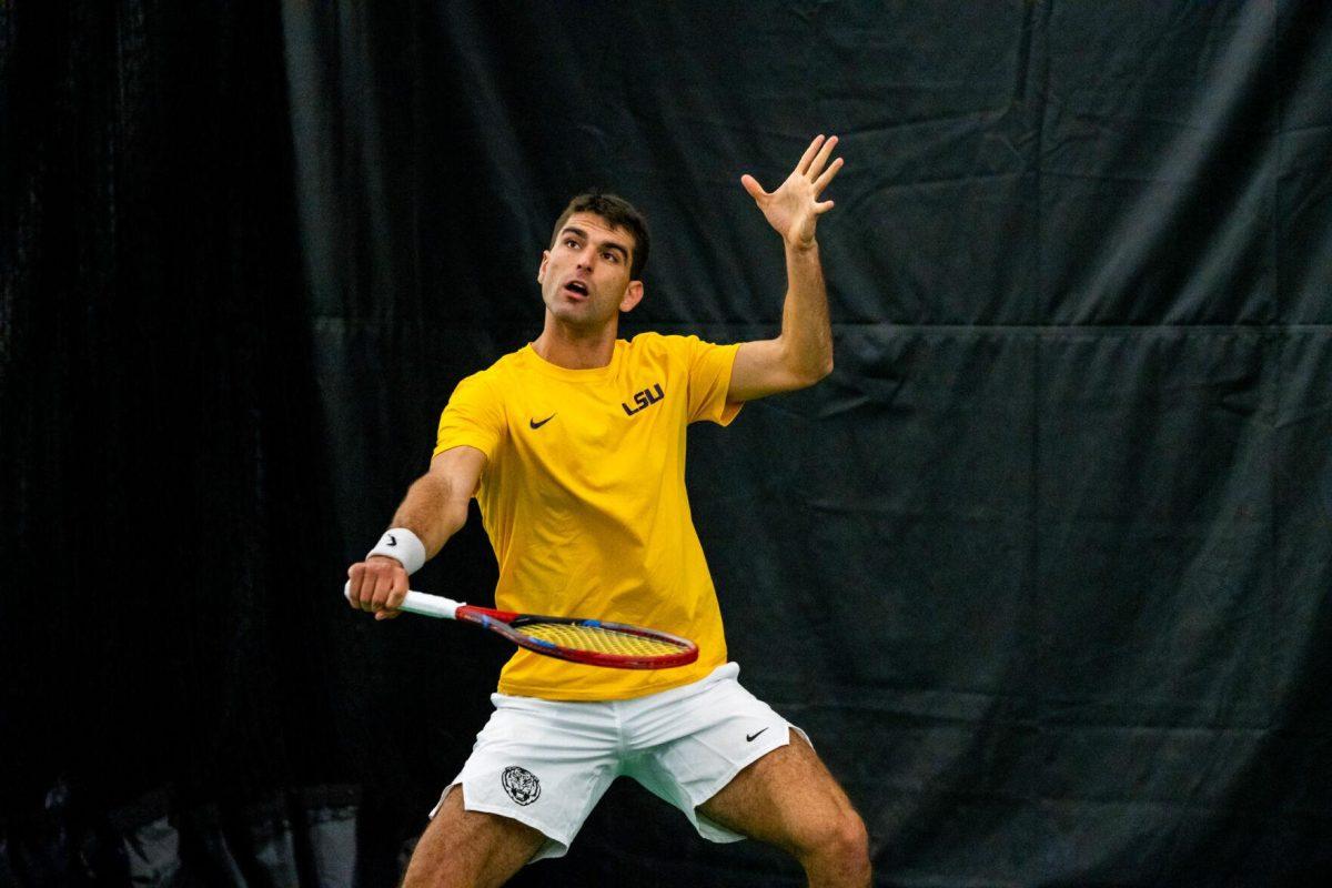 LSU men's tennis 5th-year senior Stefan Latinovic hits a lob during his 5-7 doubles match against Ole Miss Friday, March 8, 2024, at the LSU tennis complex on Gourrier Avenue in Baton Rouge, La.