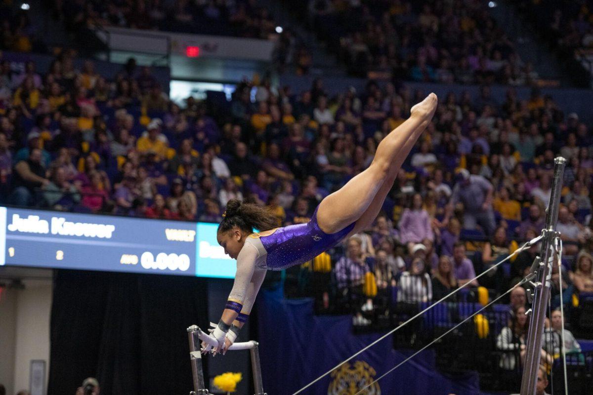 LSU gymnastics freshman all-around Konnor McClain spins on the uneven bars Friday, March 15, 2024, during LSU's 198.250-196.075 win against North Carolina at the Pete Maravich Assembly Center in Baton Rouge, La.