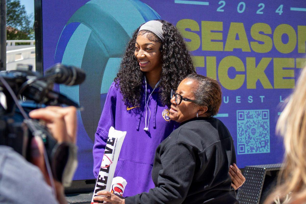 LSU women's basketball junior forward Angel Reese (10) poses for a photo with a fan at the Sweet Sixteen Sendoff on Thursday, March 28, 2024, outside the Pete Maravich Assembly Center in Baton Rouge, La.