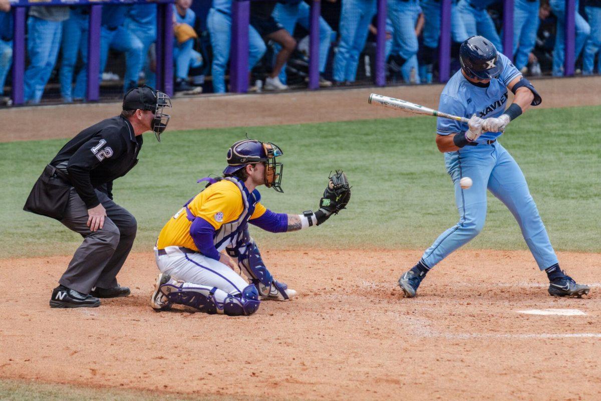 LSU baseball graduate student catcher Hayden Travinski (8) watches the ball Sunday, March 10, 2024, during LSU's 2-1 loss to Xavier in Alex Box Stadium in Baton Rouge, La.