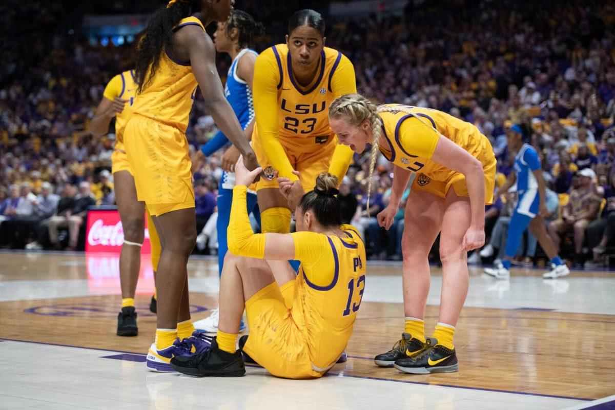 LSU women's basketball players celebrate and help junior guard Last-tear Poa (13) up Sunday, March 3, 2024, during LSU&#8217;s 77-56 win against Kentucky at the Pete Maravich Assembly Center in Baton Rouge, La.