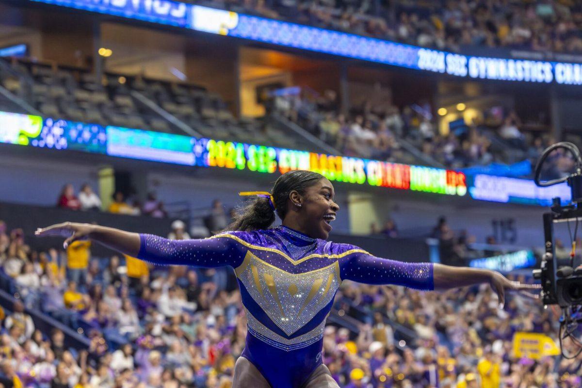 LSU gymnastics graduate student all-around Kiya Johnson celebrates her balance beam routine Saturday, March 23, 2024, during LSU's 198.075 victory in the 2024 SEC Gymnastics Championship in the Smoothie King Center in New Orleans, La.