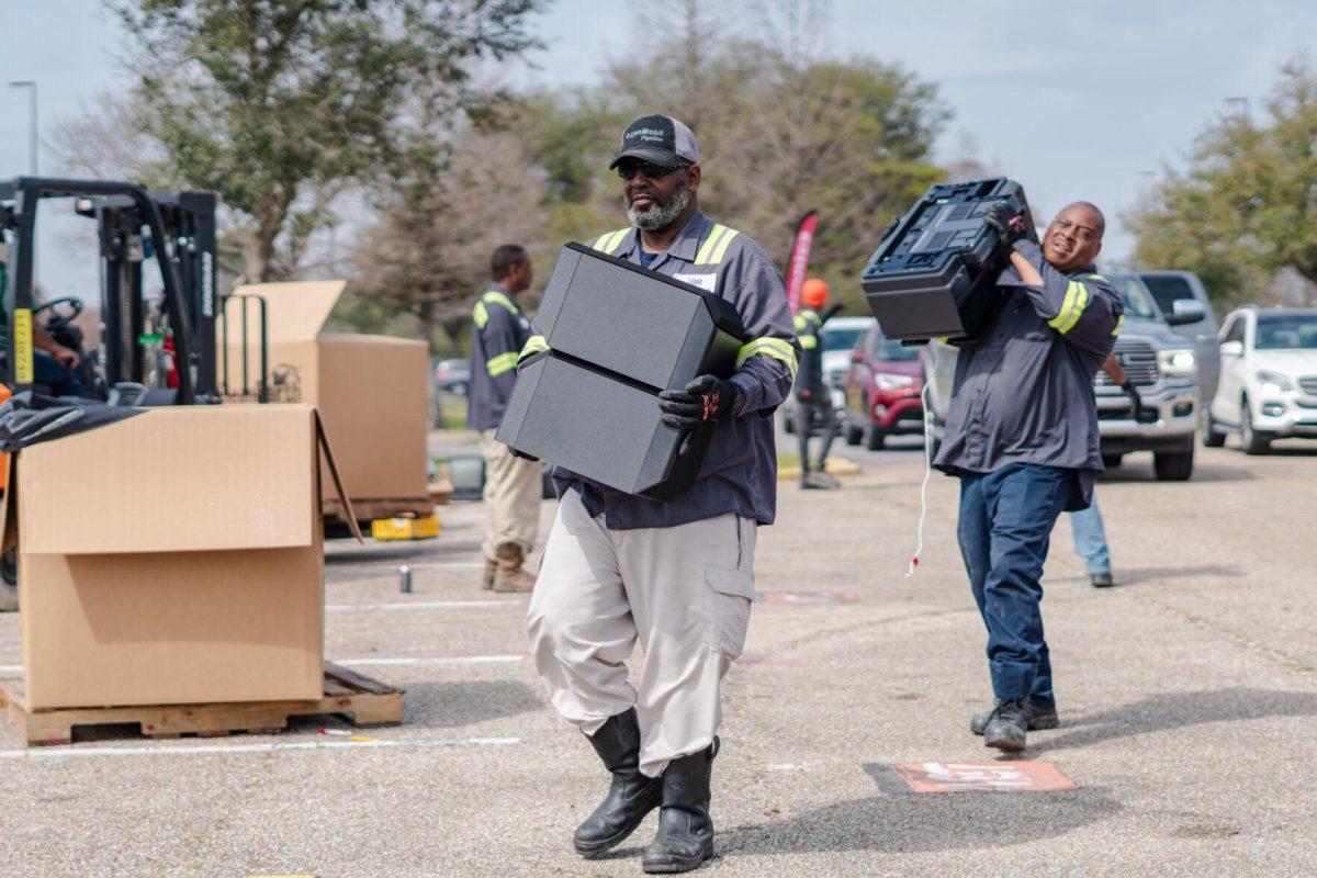 Workers carry electronics Saturday, March 2, 2024, at the Household Hazardous Materials Collection Day on LSU's campus in Baton Rouge, La.