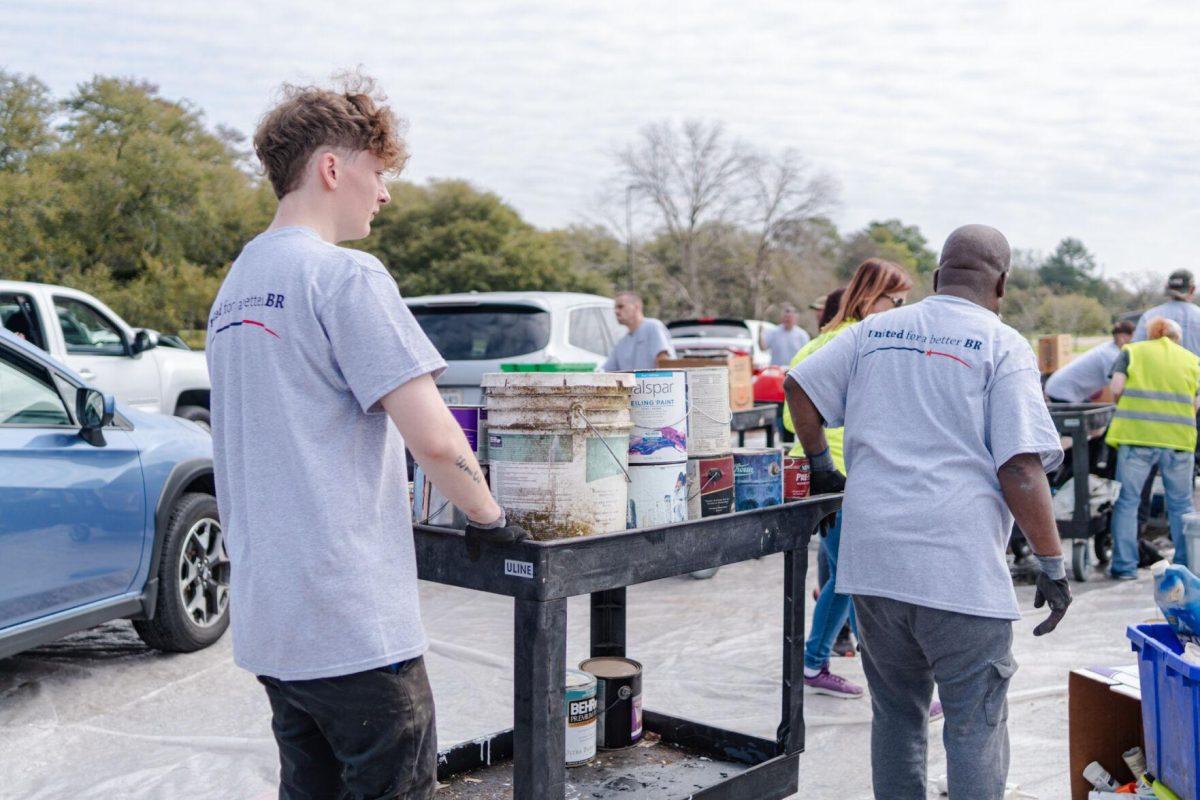 Workers cart away some paint cans Saturday, March 2, 2024, at the Household Hazardous Materials Collection Day on LSU's campus in Baton Rouge, La.