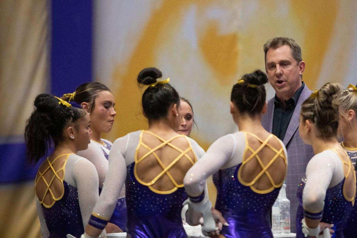 LSU gymnastics head coach Jay Clark talks to his team Friday, March 15, 2024, during LSU's 198.250-196.075 win against North Carolina at the Pete Maravich Assembly Center in Baton Rouge, La.