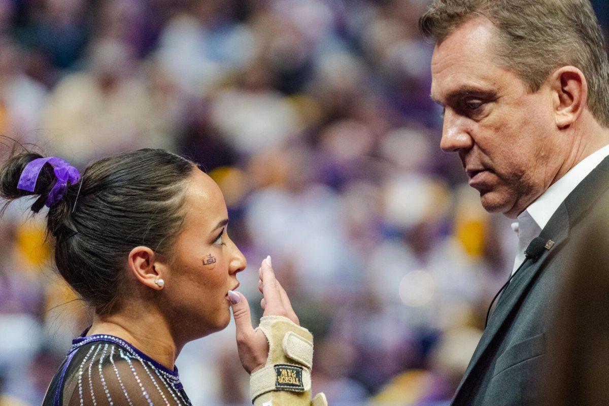 LSU gymnastics all-around junior Aleah Finnegan speaks with head coach Jay Clark Friday, March 1, 2024, during LSU&#8217;s 198.325-197.325 win against Alabama in the Pete Maravich Assembly Center in Baton Rouge, La.