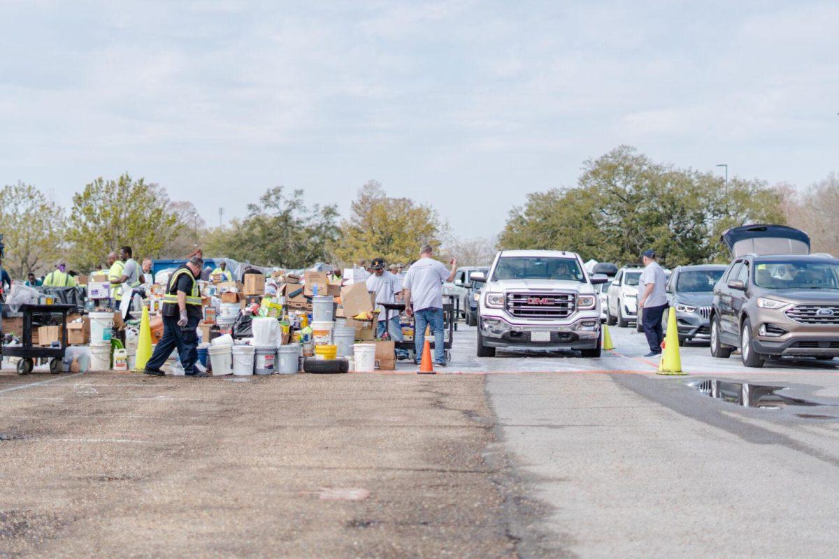 Workers direct traffic and remove items from the vehicles Saturday, March 2, 2024, at the Household Hazardous Materials Collection Day on LSU's campus in Baton Rouge, La.