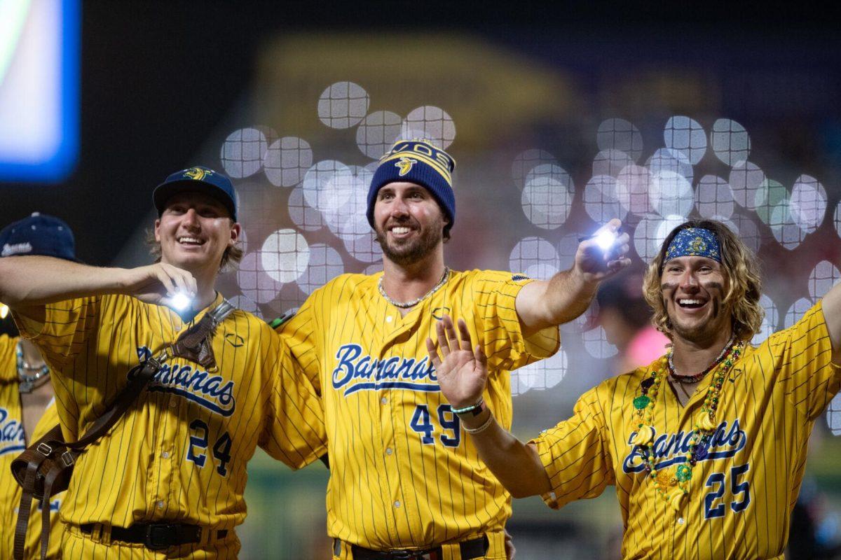 The Savannah Bananas wave flashlights as Coldplay's "Yellow" plays Thursday, March 14, 2024, during the Savannah Bananas 5-4 loss to the Party Animals during their world tour stop at Alex Box Stadium in Baton Rouge, La.