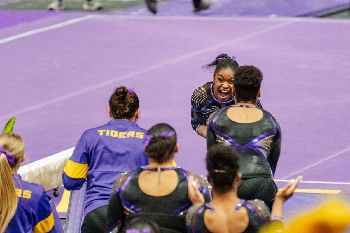 LSU gymnastics all-around graduate student Kiya Johnson celebrates after competing on the balance beam Friday, March 1, 2024, during LSU&#8217;s meet against Alabama in the Pete Maravich Assembly Center in Baton Rouge, La.