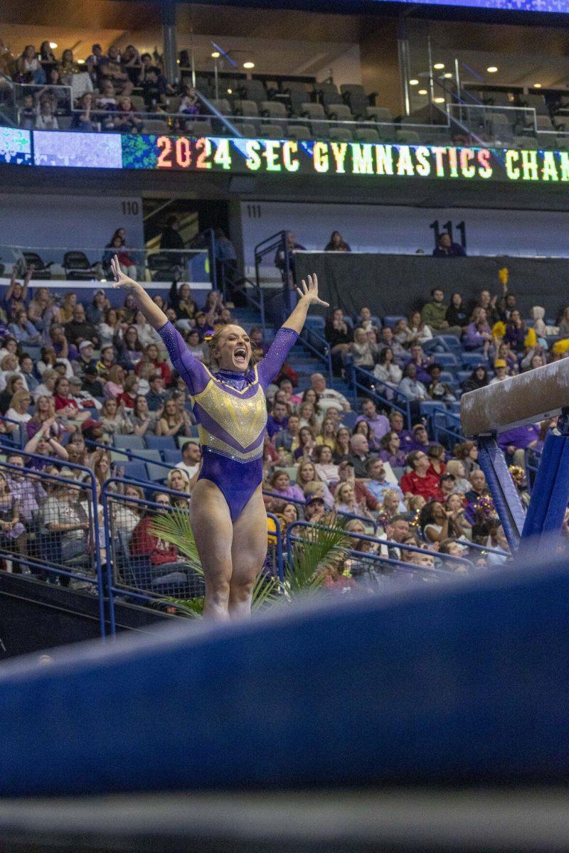 LSU gymnastics graduate student all-around Savannah Schoenherr celebrates a stick landing Saturday, March 23, 2024, during LSU's 198.075 victory in the 2024 SEC Gymnastics Championship in the Smoothie King Center in New Orleans, La.