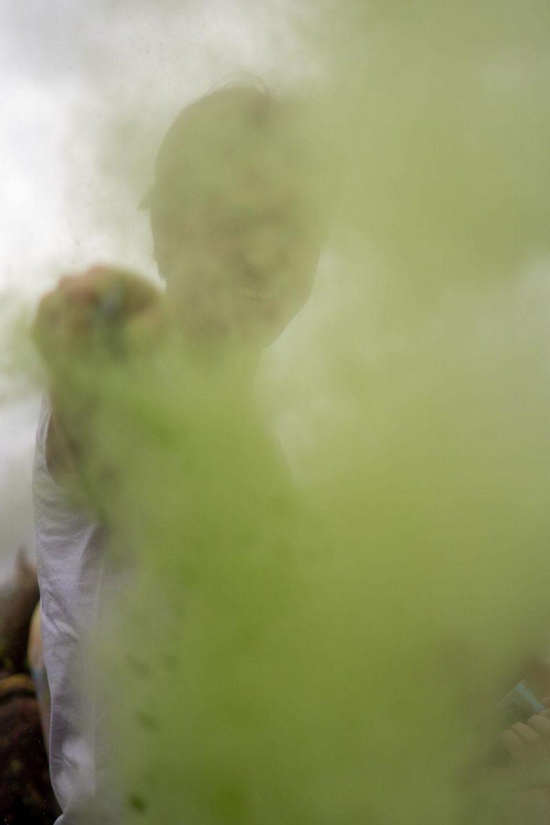 A man throws colored powder Saturday, March 9, 2024, at the Holi Festival at Repentance Park in Baton Rouge La.