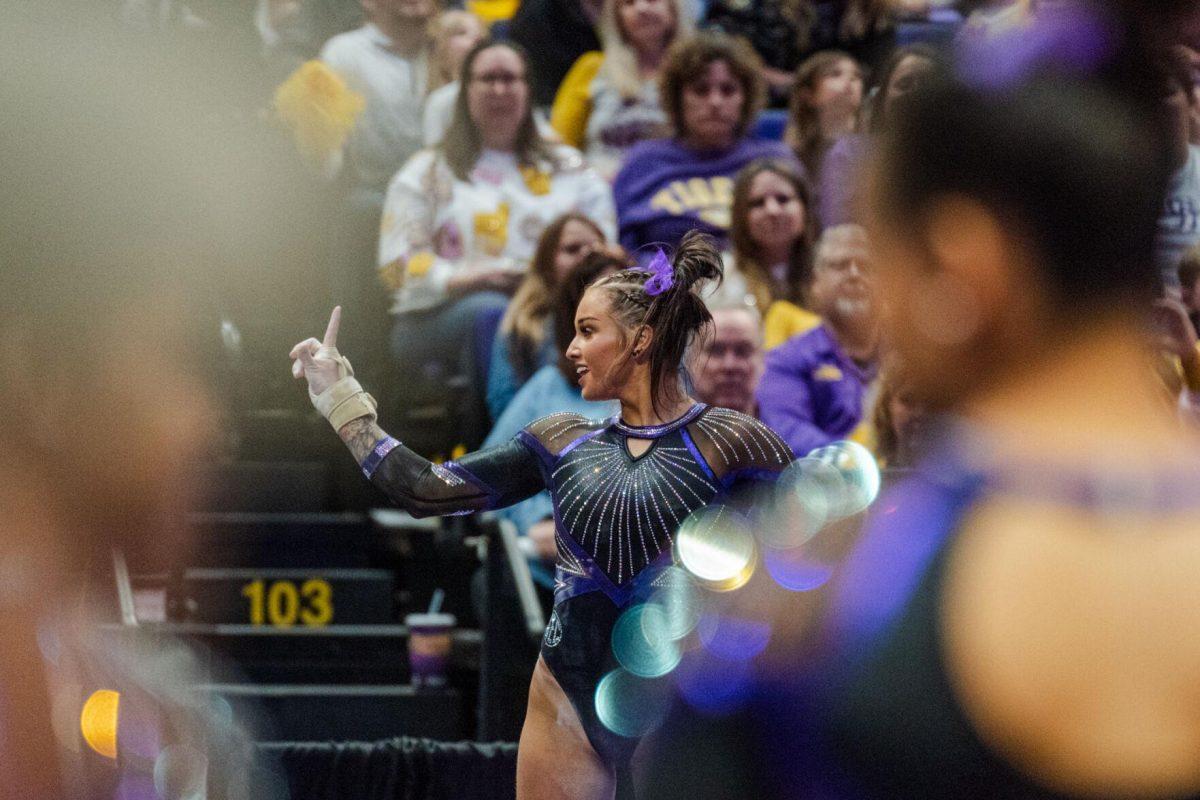 LSU gymnastics all-around junior KJ Johnson strikes a pose Friday, March 1, 2024, during LSU&#8217;s 198.325-197.325 win against Alabama in the Pete Maravich Assembly Center in Baton Rouge, La.