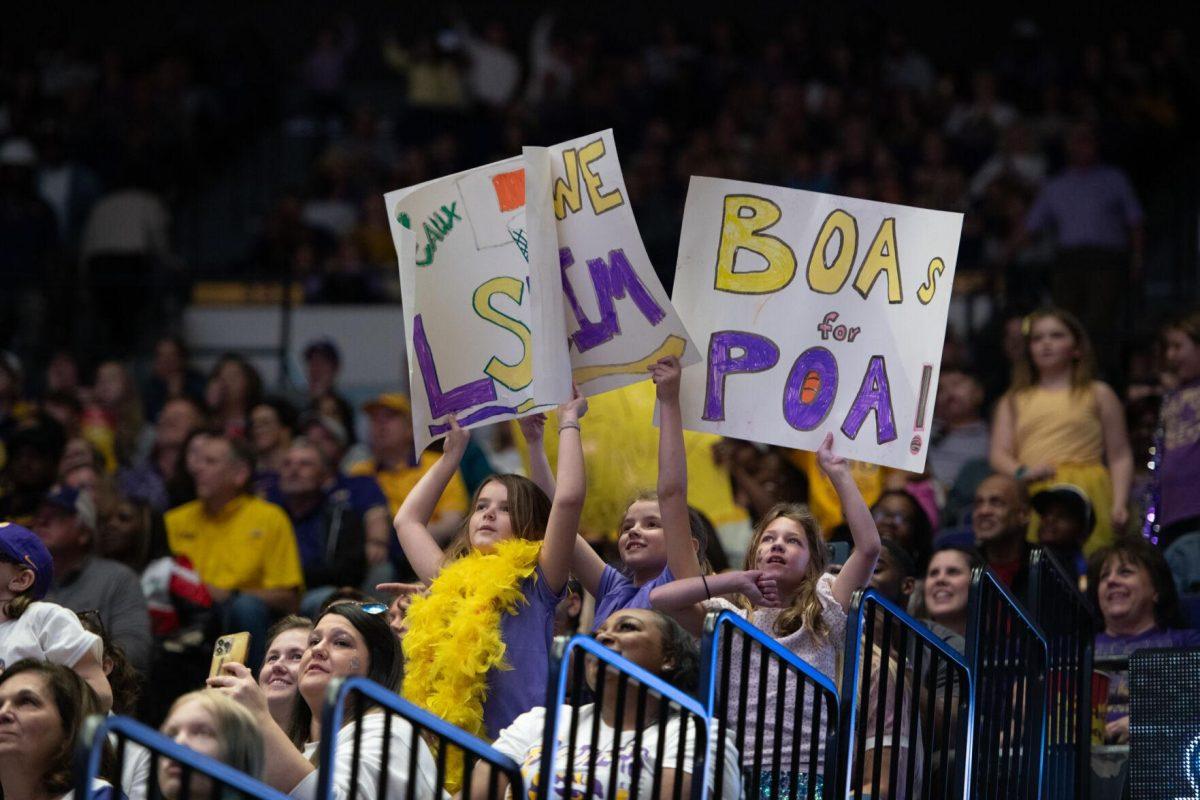 Young LSU women&#8217;s basketball fans hold up signs Sunday, March 24, 2024, during LSU&#8217;s 83-56 second-round NCAA tournament win against Middle Tennessee at the Pete Maravich Center in Baton Rouge, La.