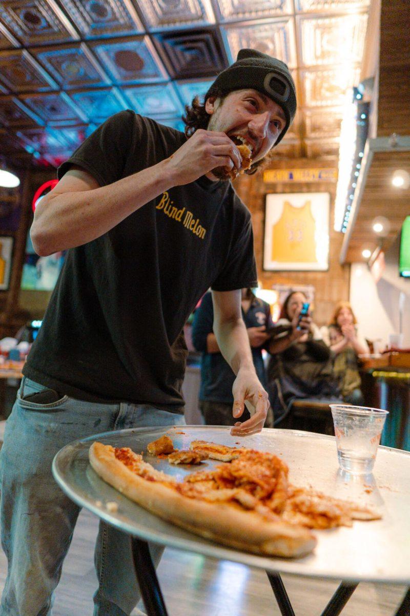 Jacob Chastant makes his final efforts during the challenge as time winds down Sunday, Feb. 18, 2024, at Fat Boy's Pizza on Nicholson Drive in Baton Rouge, La.