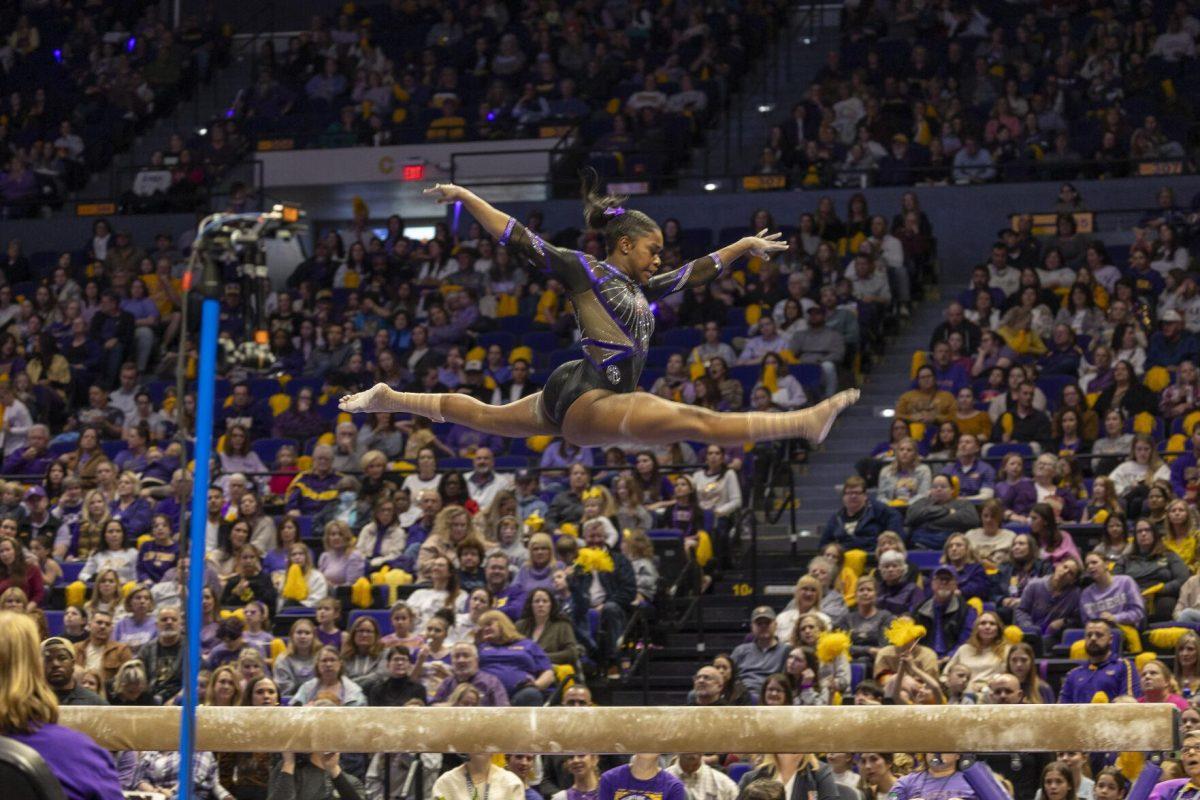 LSU gymnastics graduate student Kiya Johnson splits through the air Friday, March 1, 2024, during LSU's 198.325-197.325 win over Alabama in the Pete Maravich Assembly Center.