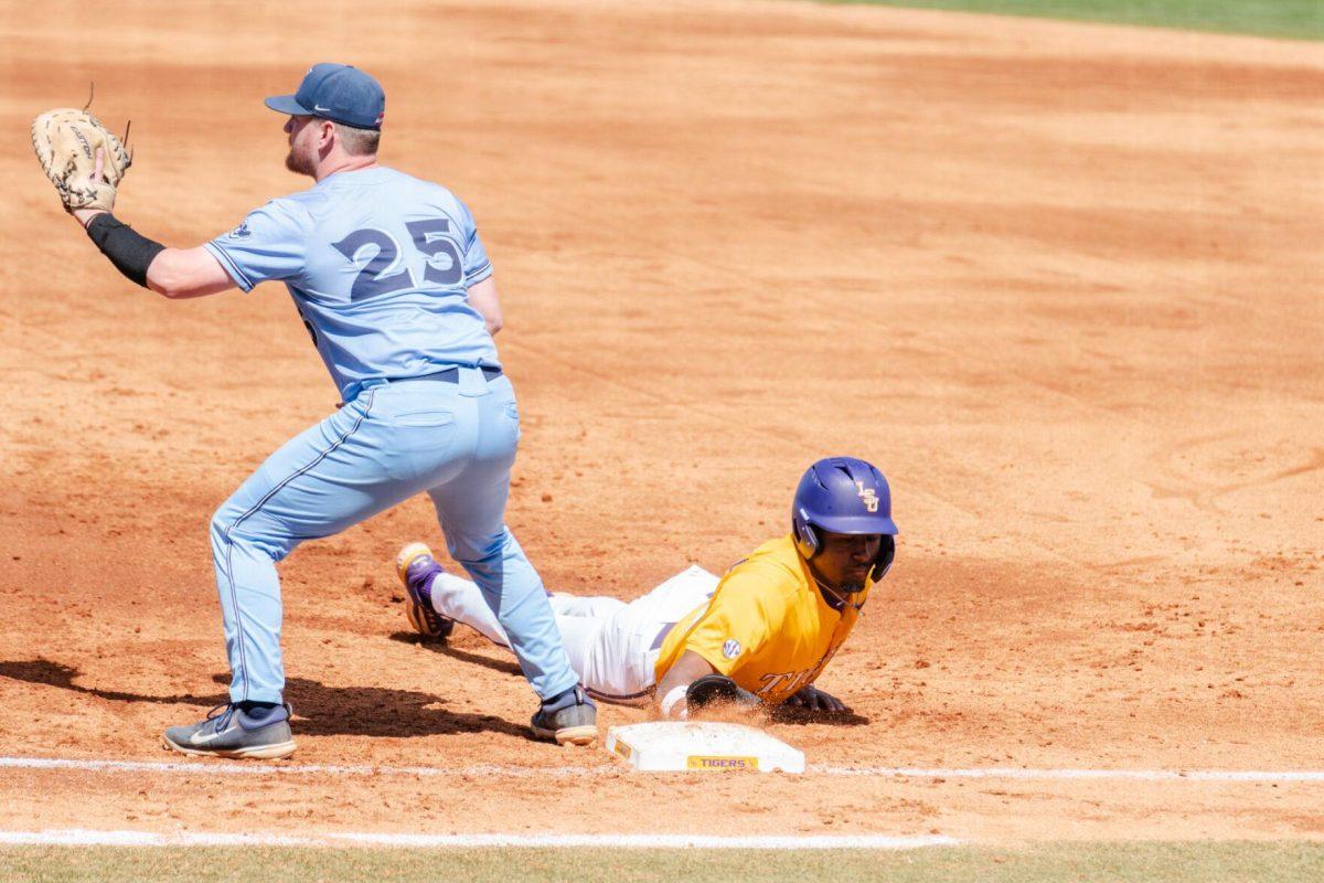 LSU baseball junior shortstop Michael Braswell III (10) dives into first base Sunday, March 10, 2024, during LSU's 2-1 loss to Xavier in Alex Box Stadium in Baton Rouge, La.