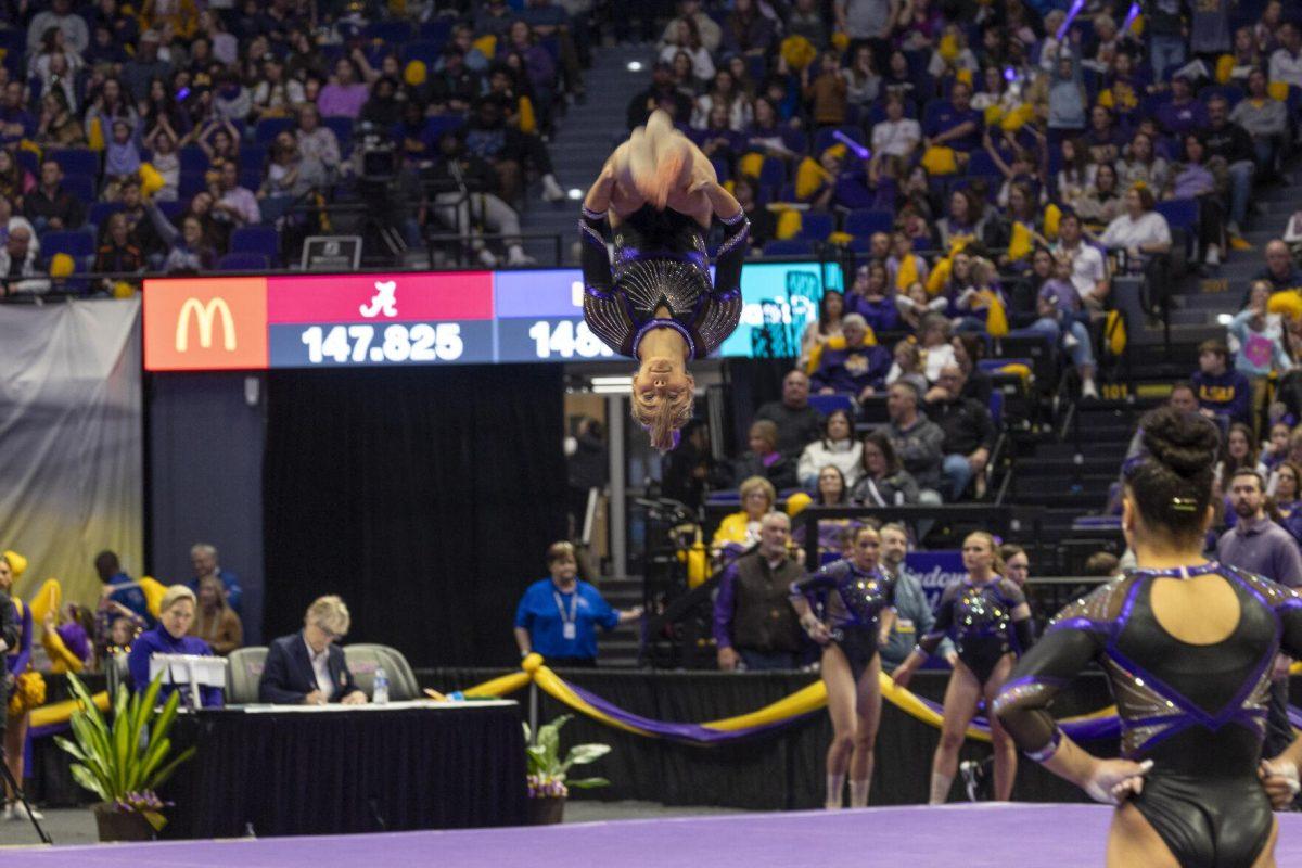 LSU gymnastics senior all-around Olivia Dunne flips upside down Friday, March 1, 2024, during LSU's 198.325-197.325 win over Alabama in the Pete Maravich Assembly Center.