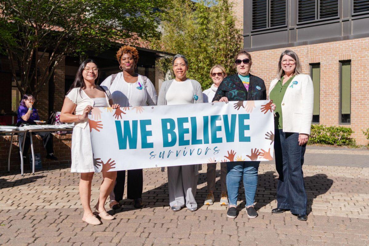 Confidential supporters stand for a photo Tuesday, March 26, 2024, at the Believe March on LSU's campus.