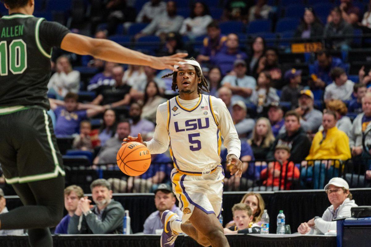 LSU men&#8217;s basketball senior forward Mwani Wilkinson (5) dribbles the ball Tuesday, March 19, 2024, during LSU&#8217;s 84-77 loss to the University of North Texas at the PMAC in Baton Rouge, La.