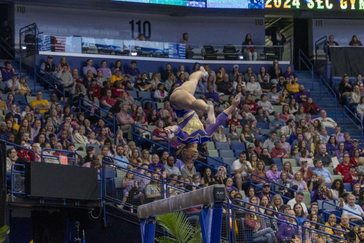 LSU gymnastics freshman all-around Konnor McClain somersaults on the balance beam Saturday, March 23, 2024, during LSU's 198.075 victory in the 2024 SEC Gymnastics Championship in the Smoothie King Center in New Orleans, La.
