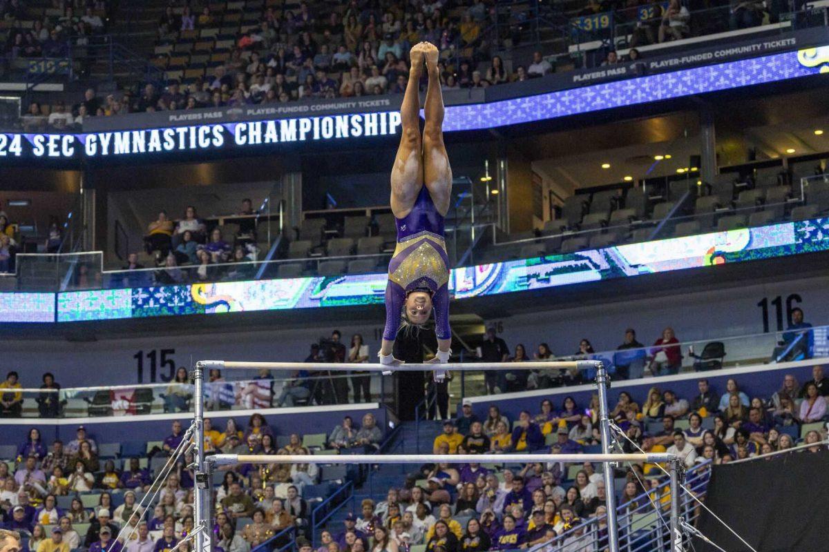 LSU gymnastics sophomore all-around Ashley Cowan makes a handstand on the uneven bars Saturday, March 23, 2024, during LSU's 198.075 victory in the 2024 SEC Gymnastics Championship in the Smoothie King Center in New Orleans, La.