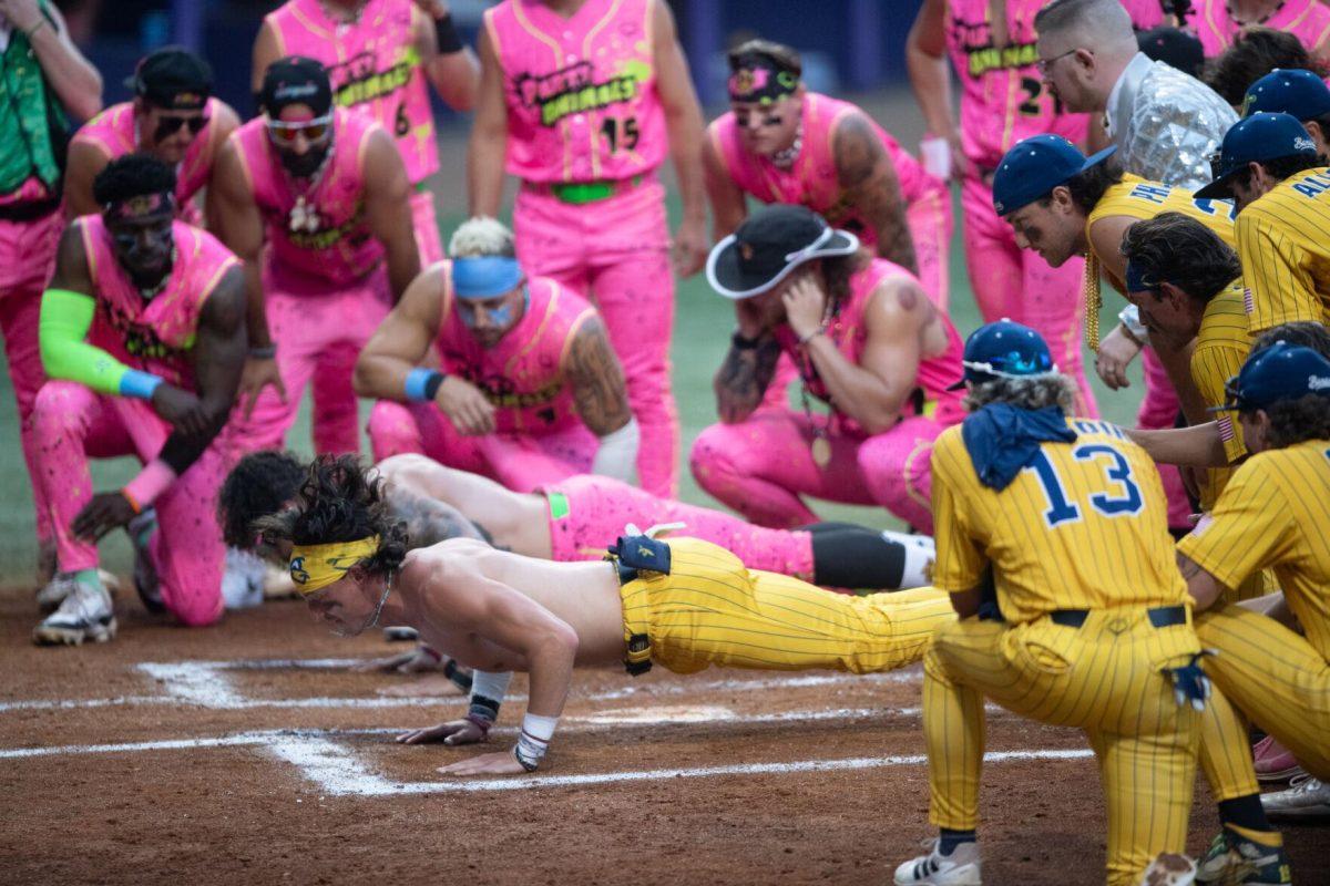 The Savannah Bananas and Party Animals compete in a push-up contest Thursday, March 14, 2024, before the Savannah Bananas 5-4 loss to the Party Animals during their world tour stop at Alex Box Stadium in Baton Rouge, La.