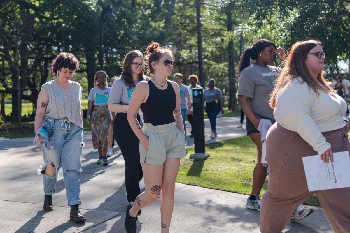 Attendees walk the route in silence Tuesday, March 26, 2024, at the Believe March on LSU's campus.