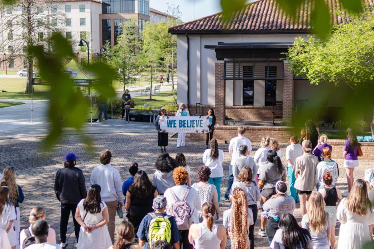 Attendees listen to Director of the Lighthouse Program Kreslyn Kelley-Ellis speak after the march Tuesday, March 26, 2024, at the Believe March on LSU's campus.