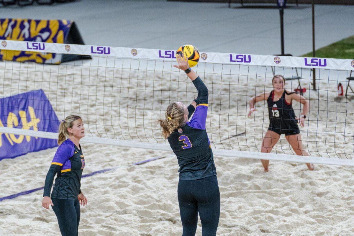 LSU beach volleyball junior Ella Larkin (3) hits the ball Saturday, March 2, 2024, during LSU&#8217;s 5-0 win against Nebraska at the LSU Beach Volleyball Stadium in Baton Rouge, La.